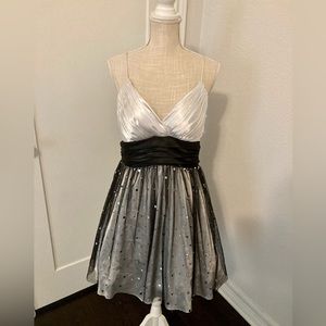 Black and white strapless dress with a puffy skirt and zipper in the back.